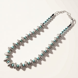 Necklace with blue and silver beads on a white background
