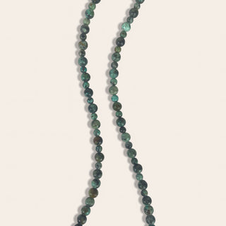 Necklace with green beads on a white background