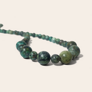 Necklace with green beads on a white background