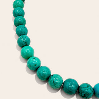 turquoise beaded jewelry on a beige background