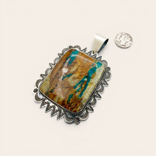 Jewelry pendant with stone and silver frame on a white background