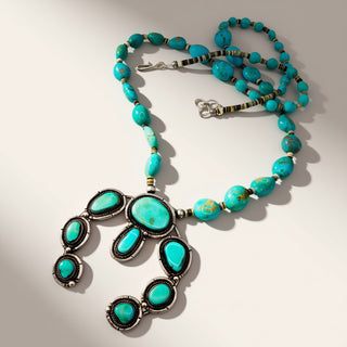 turquoise beaded necklace on a beige background