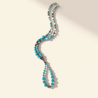 Turquoise beaded necklace on a beige background