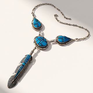 Necklace with blue stone pendants and a feather design on a white background