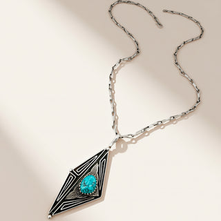 silver and turquoise necklace on a beige background