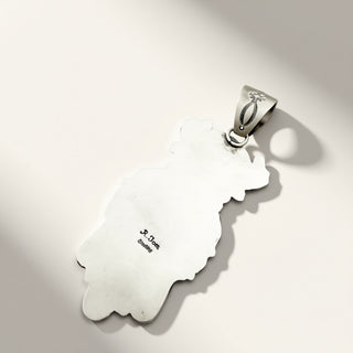 A sterling silver pendant featuring a bail with a small floral engraving, displayed on a light gray background with soft shadows.