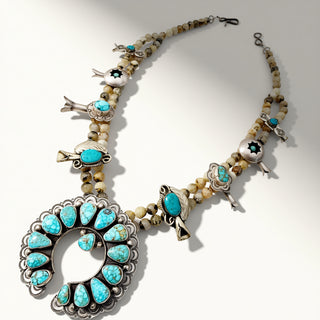 Necklace with turquoise stones and silver accents on a white background