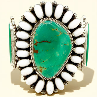 Turquoise stone cuff with white stones on a beige background