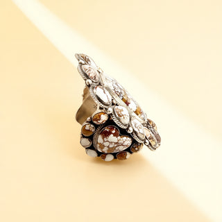 Close-up of a decorative cuff with intricate design on a beige background