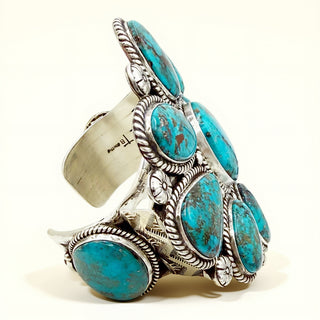 Silver and turquoise cuff bracelet on a white background