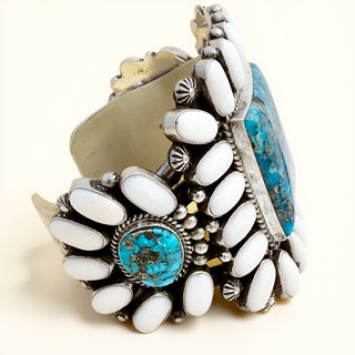 Decorative bracelet with white stones and turquoise accents on a beige background