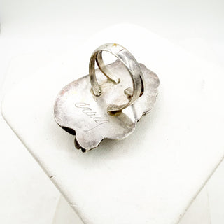 Silver ring on a white stone surface