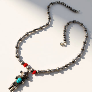 Necklace with beads and a charm on a white background